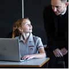 Teacher and student with laptop